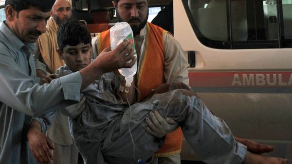 Pakistani volunteers move a victim injured in a suicide bombing to a hospital in Peshawar on March 7, 2016, after an attack on a court complex in the town of Shabqadar. (AFP/Hasham Ahmed)