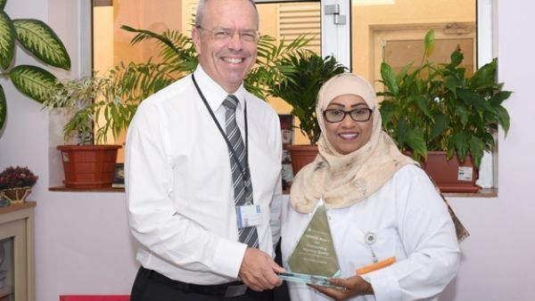 Ms. Ghaya Al Tamimi and Dr. Steven Beaumont, Rumailah Hospital, HMC, with their NDNQI award