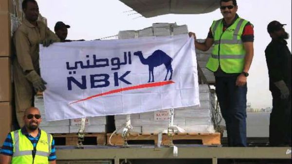 NBK staff in front of the cargo plane to Somalia
