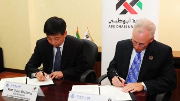 Professor Yuan Decheng, Vice Principal in charge of Foreign Affairs, Shenyang University of Chemical Technology and Dr. James Macking, Provost, Abu Dhabi University, signing the MoU Professor Yuan Decheng, Vice Principal in charge of Foreign Affairs, Shenyang University of Chemical Technology and Dr. James Macking, Provost, Abu Dhabi University, signing the MoU