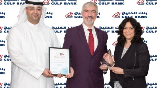 Laila Al-Qatami and Ahmed Al-Fassam receiving the award on behalf of Gulf Bank