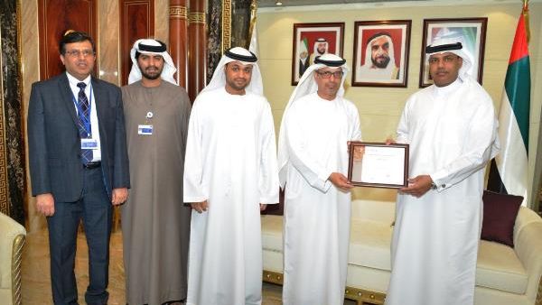 Juma Al Ghaith presents Ahmed Mahboob Musabih with the COBIT 5 certificate, in presence of Ahmad Al Yaqoobi, Project Delivery Director and Adel Al Hosani, Head of Information Security