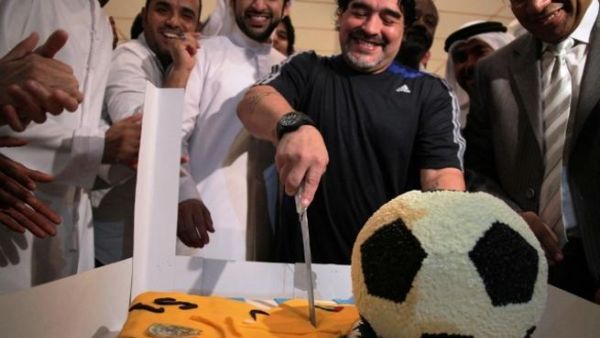 Diego Maradona cutting his birthday cake