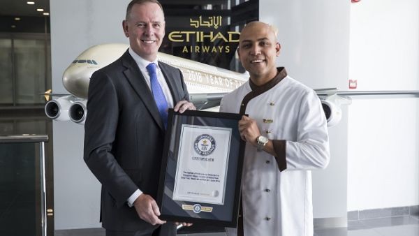 Tony Douglas, Group Chief Executive Officer, Etihad Aviation Group, congratulates Etihad Airways Inflight Chef, Sanjay Thakur.
