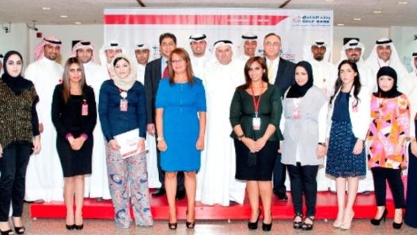 Surour Alsamerai, General Manager, Human Resources and Aly Shalaby, General Manager, Consumer Banking Group at Gulf Bank along with employees after receiving their certificates