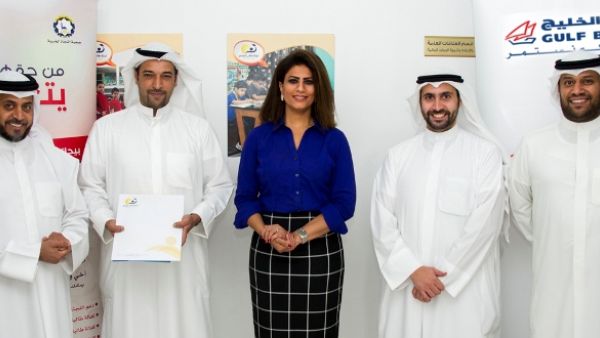 Gulf Bank representatives delivering the scholarship donation for orphans to the Committee of Knowledge Seekers on the occasion of International Literacy Day