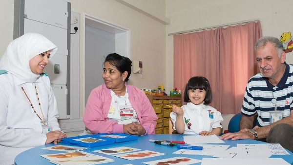 Haya Al Neemi with specialists from Child Development Center  