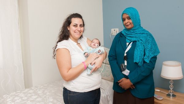 Dr. Amani Saeed Ibrahim (right) with the mother of the baby