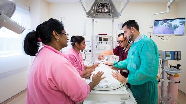 The multidisciplinary team at Women’s Hospital cares for a neonate in the NICU expansion