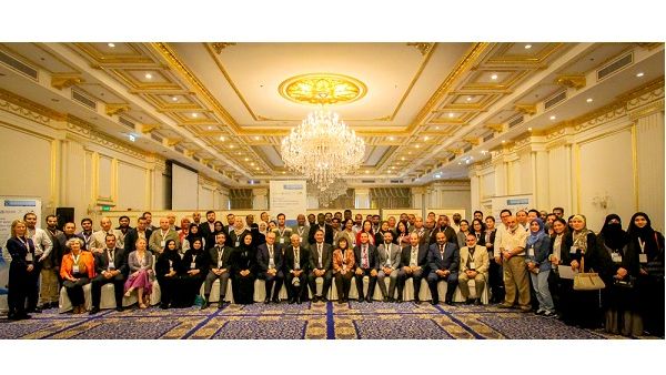 Participants and speakers at the conference pose for a group photo