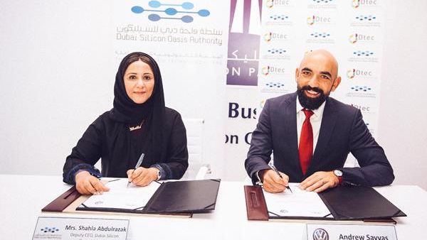 Shahla and Andrew signing the partnership agreement Shahla and Andrew signing the partnership agreement