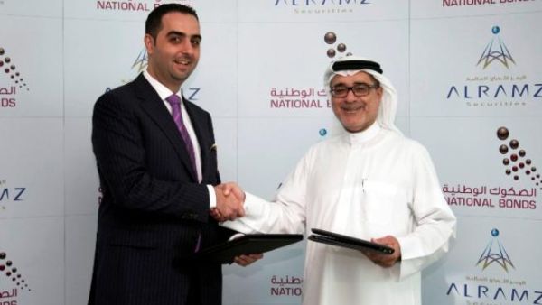 Mohammad Murtada Al Dandashi, Partner and Managing Director, Al Ramz Securities and Mohammed Qasim Al Ali, CEO of National Bonds Corporation shaking hands