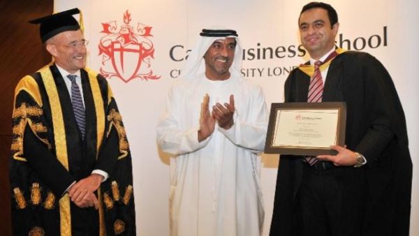 Sheikh Ahmed bin Saeed Al Maktoum and Professor Paul Curran delivering the Cass Executive MBA degree to a student