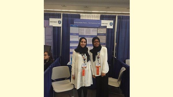Winning team from Qatar with their project display board at Intel ISEF in the United States