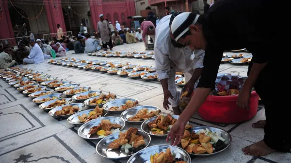 A Pakistani Muslim man arranges Iftar food for Muslim devotees before they break their fast during the holy fasting month of Ramadan in Karachi on June 30, 2014. (AFP/Asif Hassan)