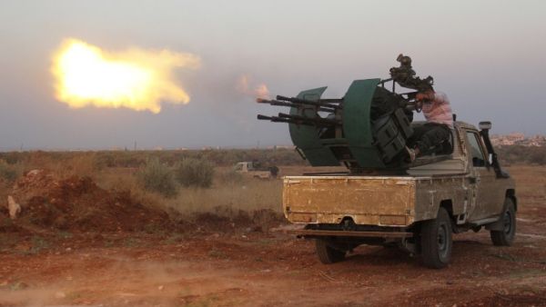 Rebel fighters fire a heavy machine gun during clashes with Syrian pro-government forces on the frontline facing Deir al-Zoghb, a government-held area in the northwestern Idlib province, on Aug. 31, 2015. (AFP/Omar Haj Kadour)