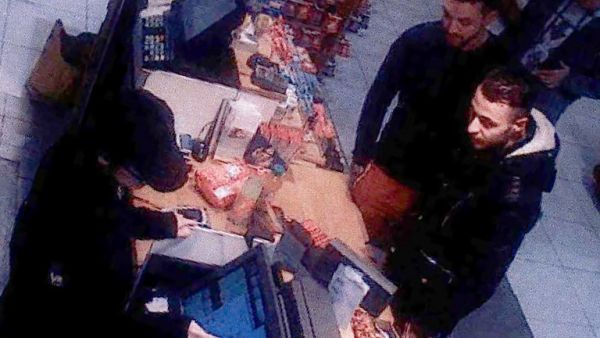 This file video image taken from a CCTV camera at a petrol station north of Paris on November 11, 2015 shows Salah Abdeslam (R), a suspect in the Paris attacks, and Mohamed Abrini (C) buying goods. (AFP/File)
