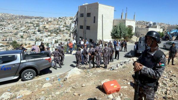 Jordanian security forces gather near a damaged building in the city of Salt, northwest of the capital Amman, on August 12, 2018. AFP