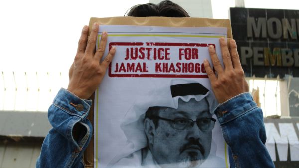 Humanitarian activists hold a poster with a picture of Jamal Khashoggi demonstrating in Makassar. Jamal Khashoggi, a journalist who was killed in Turkey (Shutterstock)