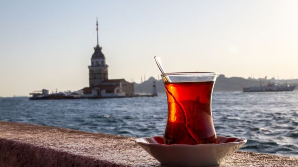 A cup of Turkish tea on the background of the Maiden Tower. (Shutterstock)
