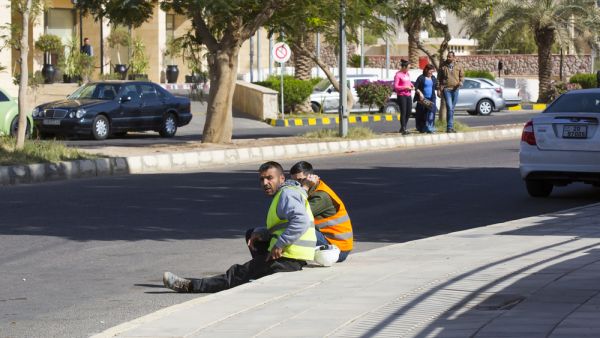 Construction workers resting on the street at lunchtime (Shutterstock)
