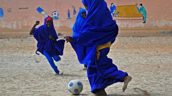Somali school girls play football during lunch break at the Howlwadag Primary School in Howlwadag District, south of Mogadishu, on October, 5, 2016. (AFP/Mohamed Abdiwahab)