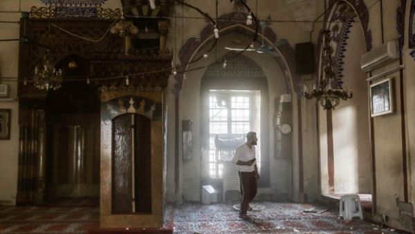 People search for injured people inside a mosque after it was hit by a rocket fired into Turkey from an area of Syria controlled by the Islamic State. (AFP/File)