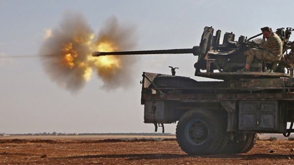 Fighters from the Free Syrian Army fire an anti-aircraft machine gun mounted on a vehicle deploy during fighting against the Islamic State (IS) group jihadists in the northern Syrian village of Yahmoul. (AFP/File)
