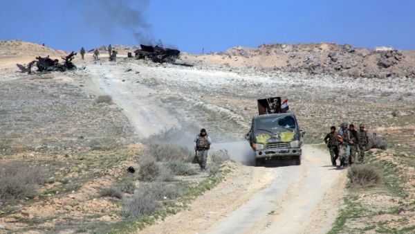 Syrian pro-government forces advance on a road through the town of Khanasser, the sole link between government-held areas in and around Aleppo and the rest of the country, after recapturing it from Daesh, on February 29, 2016. (AFP/Georges Ourfalian)