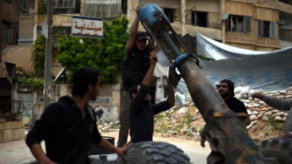 Opposition members prepare to attack the Syrian regime with cannons named "Hell and Fatah" in Aleppo. (AFP/File)