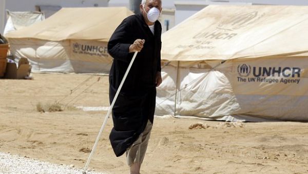 A Syrian refugee walks after undergoing a medical check at a Moroccan military field hospital in the Zaatari camp for Syrian refugees, on Aug. 11, 2012. (AFP/Khalil Mazraawi)