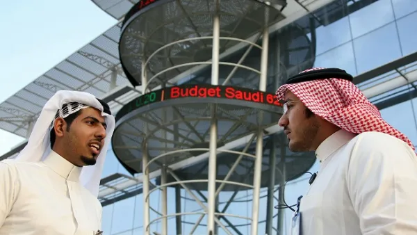 Saudi men chat outside the Saudi Stock Exchange in Riyadh. (AFP/ File)