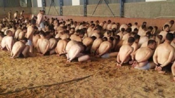 جنود مكبلي الأيدي وقد جُردّوا من بزاتهم العسكرية وأسلحتهم