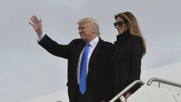 US President Donald Trump and his wife Melania step off a plane upon arrival at Andrews Air Force Base in Maryland on January 19, 2017. (AFP/ Mandel Ngan)