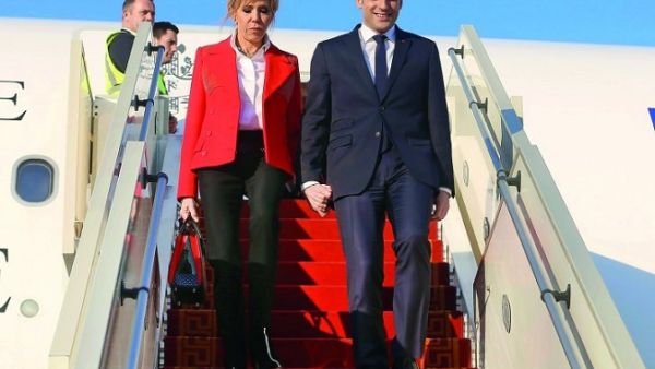 French President Emmanuel Macron and his wife Brigitte Macron descend from an airplane upon their arrival at Tunis-Carthage International Airport on January 31, 2018. (Zoubeir Souissi/ AFP) French President Emmanuel Macron and his wife Brigitte Macron descend from an airplane upon their arrival at Tunis-Carthage International Airport on January 31, 2018. (Zoubeir Souissi/ AFP)