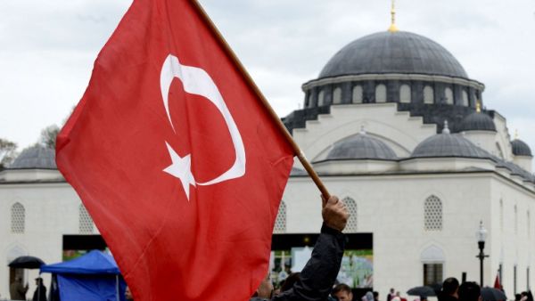 Supporters wave flags as they watch as Turkey's President Recep Tayyip Erdogan inaugurates the Diyanet Islamic Cultural Center in Lanham, Maryland on April 2, 2016. (Olivier Douliery)