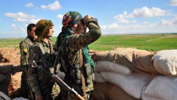 Members of the Kurdish People's Protection Units monitor the positions of Islamic State group in the Syrian town of Ras al-Ain, close to the Turkish border. (AFP/File)
