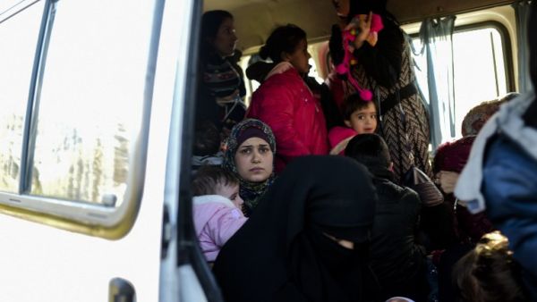 A woman looks on from inside a van after being detained by Turkish soldiers with other Syrians trying to reach the Greek island of Lesbos from Dikili, western Turkey, on March 5, 2016. (AFP/Bulent Kilic)