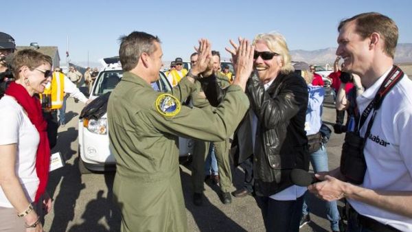 Virgin Galactic's Richard Branson and pilot Mark Stucky celebrating the successful flight of SpaceShip2 under rocket power, its first ever since the program began in 2005. (AFP/Mark Greenberg)
