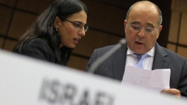 Israel's Ambassador to the IAEA prepares commentary during the meeting. The resolution to ensure Israel complies with IAEA oversight was narrowly defeated Friday (AFP)