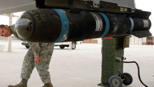 US soldier walks around an inert Hellfire missile as he perform a pre-flight check on an MQ-1B Predator unmanned aircraft system. [AFP]