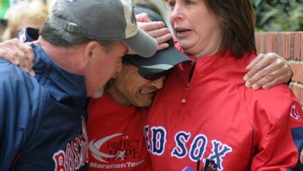 Runner crying when he finds friends after two explosions at the Boston Marathon finish line (AFP/ John Mottern)