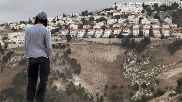 An Israeli settler looks over at an illegal settlement near Jerusalem. (AFP/File)