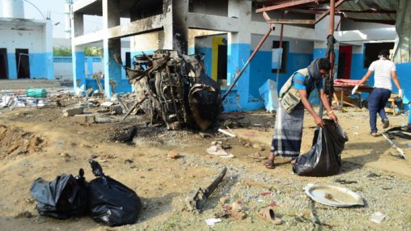 Workers clear rubble from the destroyed MSF hospital in Yemen on August 18. (AFP/File)