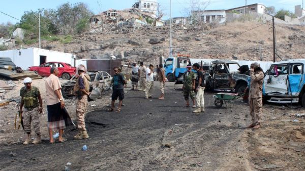 Pro-Hadi loyalist forces and civilians examine the aftermath of a suicide bombing in Aden. (AFP/Saleh al-Obeidi)