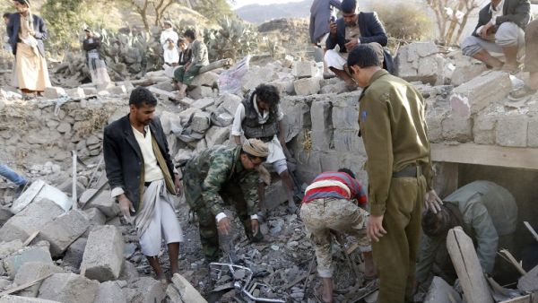 Yemeni men clear rubble from a previous Saudi airstrike near Sanaa. (AFP/File)