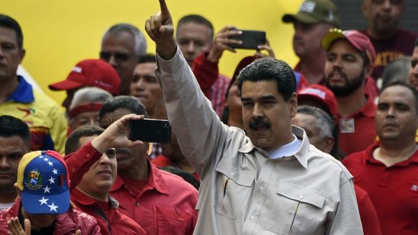 Venezuela's President Nicolas Maduro waves at supporters during a rally at the Miraflores Palace in Caracas, Venezuela (AFP)