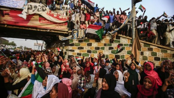 Sudanese protesters chant slogans during a demonstration demanding a civilian body to lead the transition to democracy, outside the army headquarters in the Sudanese capital Khartoum  (AFP)