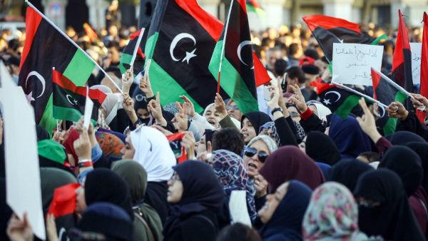 Libyan women wave national flags and chant slogans during a demonstration against strongman Khalifa Haftar in the capital Tripoli's Martyrs Square on April 12, 2019.  Mahmud TURKIA / AFP