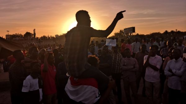 Sudanese protesters rally in the area of the military headquarters in the capital Khartoum at sunset  (AFP)